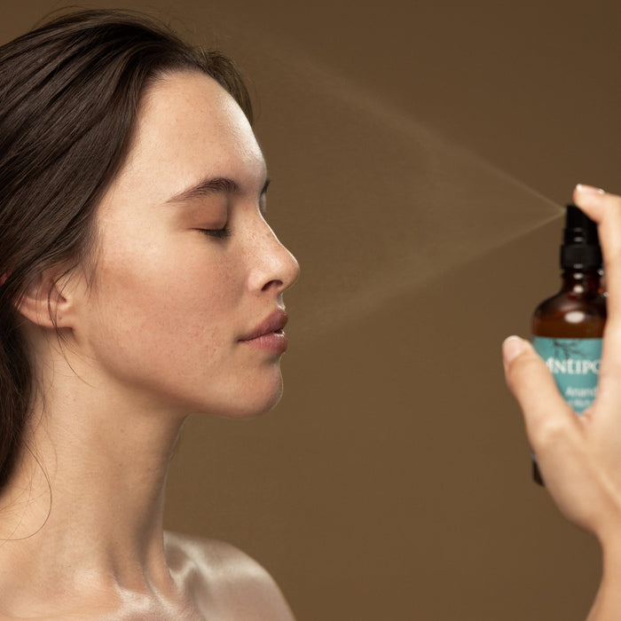A woman sprays Antipodes Ananda Antioxidant Rich Gentle Toner on her face