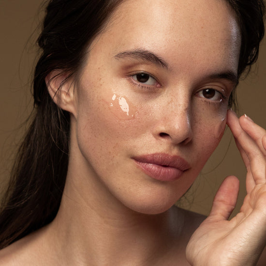 A woman applies Antipodes Baptise H20 Ultra Hydrating Water Gel Moisturiser on her face