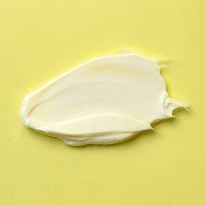 White cream smear on a yellow background