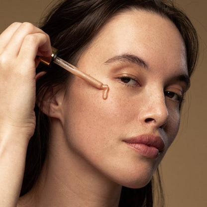 A  woman applies Antipodes Credo Probiotic Ferment Revitalise Serum on her face