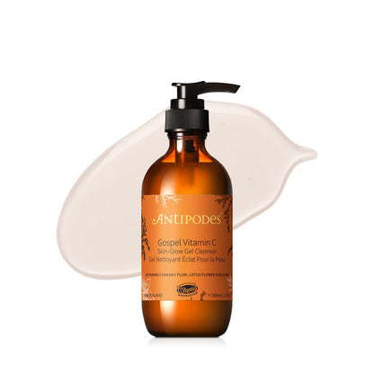 A pump bottle of Antipodes Gospel Vitamin C Skin-Glow Gel Cleanser with a clear label and orange-colored liquid visible inside.