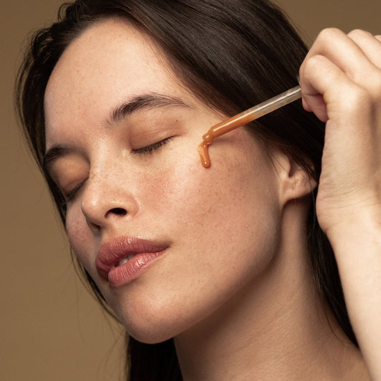 A woman applies Antipodes Hosanna H20 Intensive Plumping Skin Serum on her face