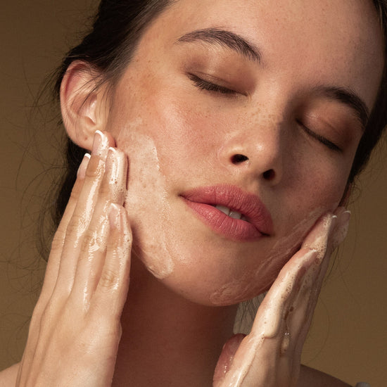 A woman cleansing her face with Antipodes Juliet Daily Balancing Gel Cleanser