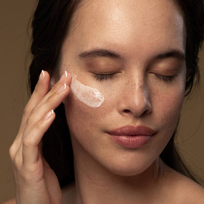 A woamn applies Antipodes Vanilla Pod Hydrating Day Cream on her face
