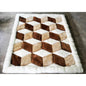 A geometric patterned rug made of alpaca fleece, featuring diamond-shaped blocks in beige, brown, and white colors.
