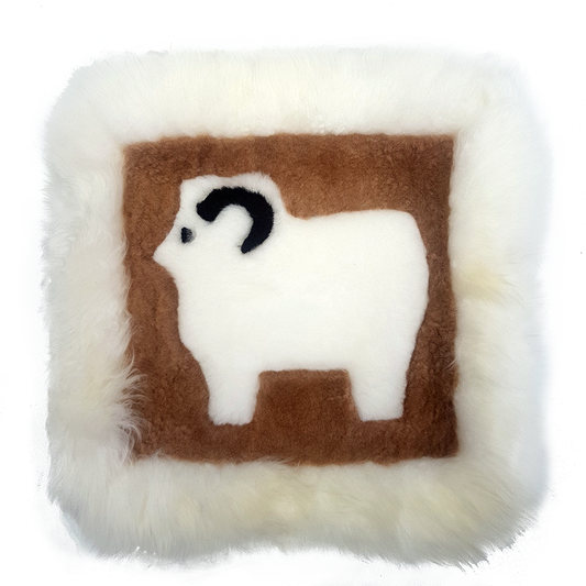 A square-shaped cushion with a brown and white alpaca design on a wool base with a brown border.